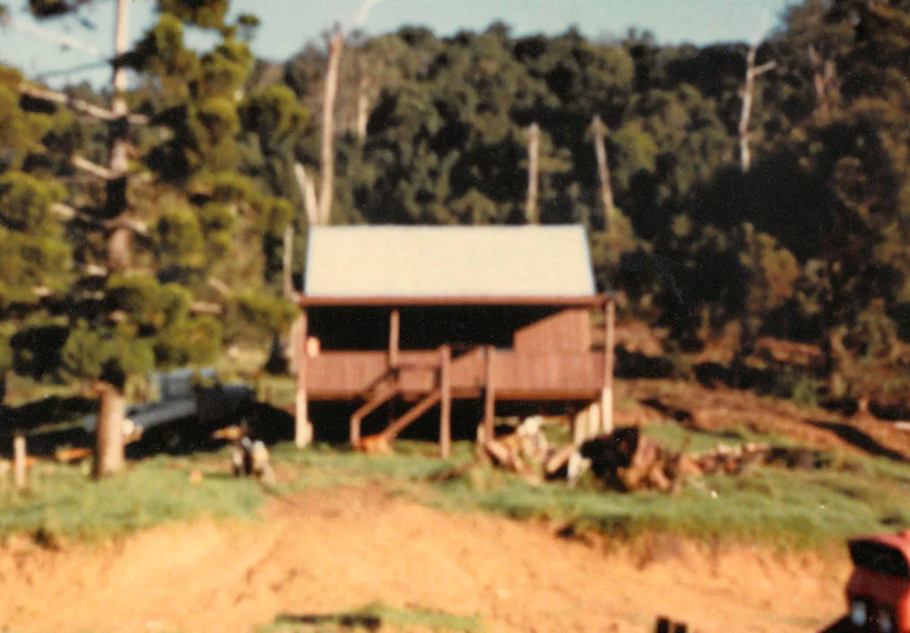 First Construction Project, Carrai-1983, by Peter Moroney Building Certifier. Timber Cabin, Motorbike, Grassy Hill, Trees,